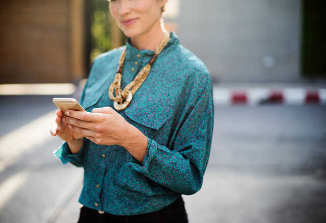 smiling woman holding a phone