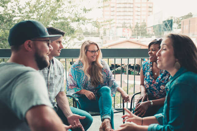young adults chatting together on a patio