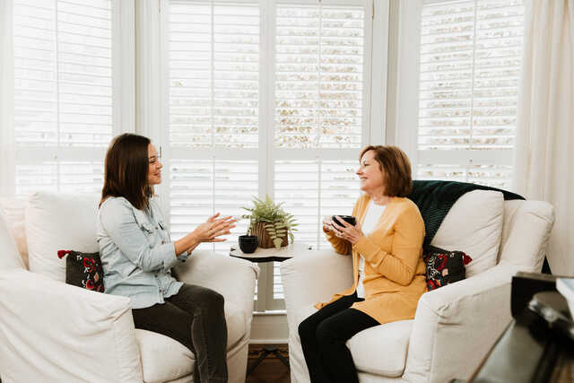 older woman having a mentoring conversation with a younger woman
