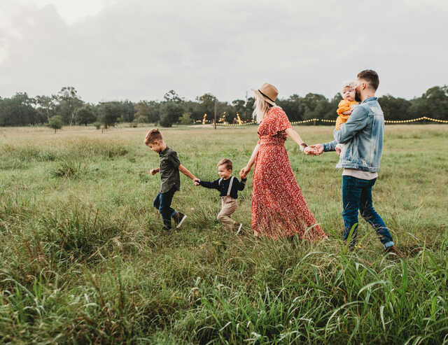 family walking together in a field