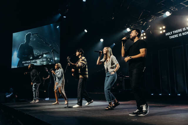 band and singers on stage leading worship