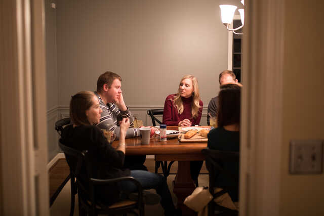married community group meeting at a kitchen table