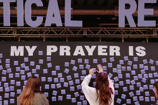 Students interacting with a prayer wall